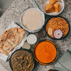 Marina Indian Restaurant - Samosas, garlic naan, saag paneer, butter chicken and chicken biryani