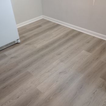 A Step Above - an empty room with wood floors - Flooring Near Me A Step Above - an empty room with wood floors - Flooring Near Me