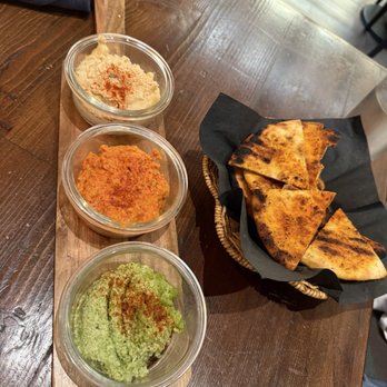 Catalan - Hummus trio. Large serving of hummus with fresh bread - Mediterranean Near Me - Rancho Mirage, California Catalan - Hummus trio. Large serving of hummus with fresh bread - Mediterranean Near Me - Rancho Mirage, California