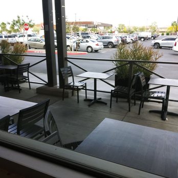 Starbucks - a view of a parking lot through a window - Coffee & Tea Near Me - Mesa, Arizona