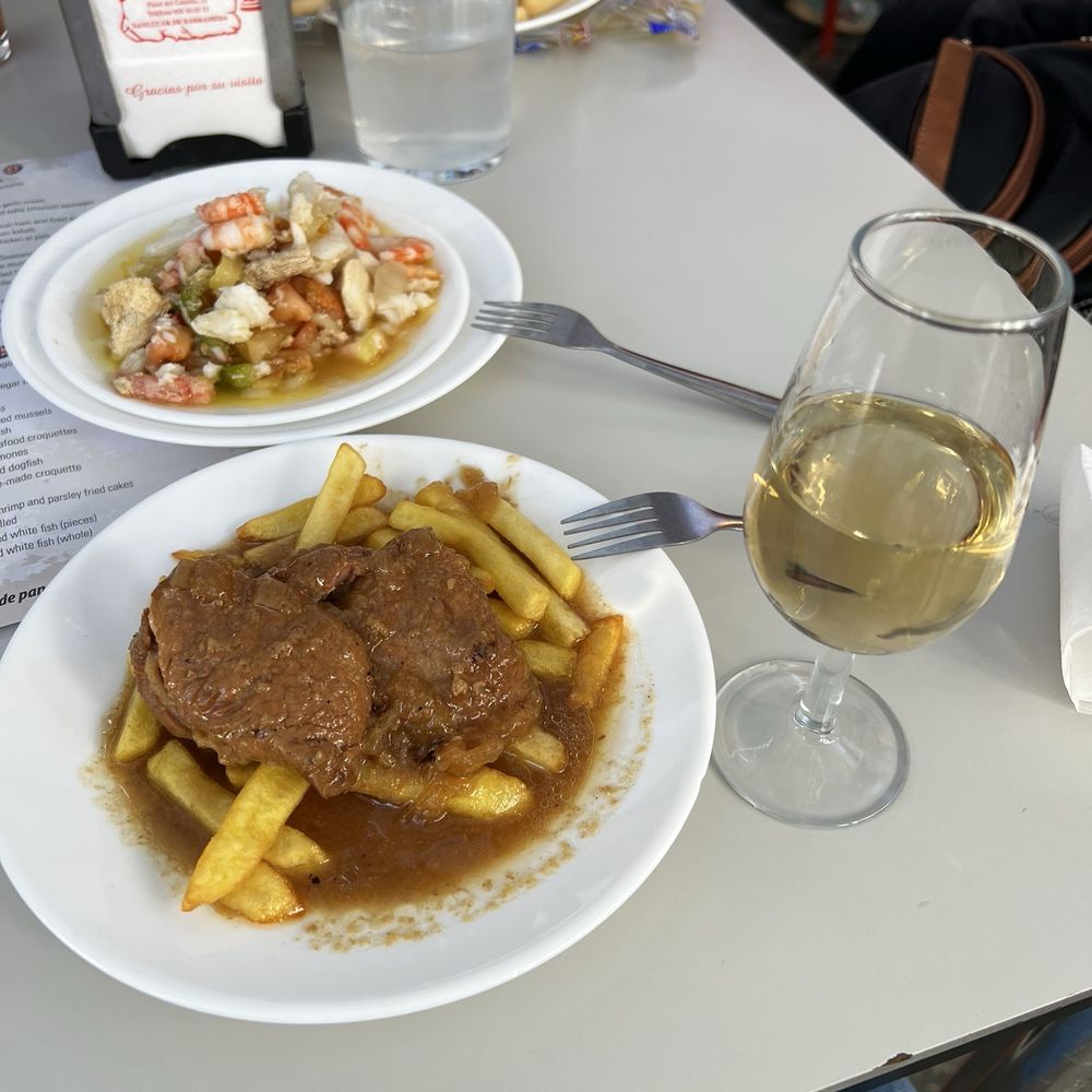 Casa Balbino - Salpicón in the background and solomillo de cerveza and a copa of manzanilla - Tapas/Small Plates Near Me - Sanlucar de Barrameda, California