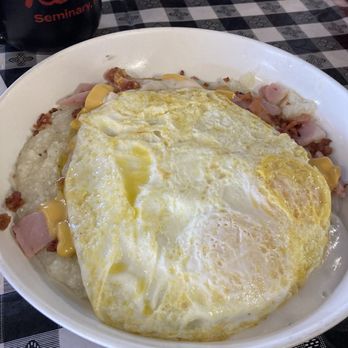 Reds Dine In - Grits bowl- with ham, bacon, sausage, gravy, eggs to order and a biscut on the side. - Burgers Near Me - Seminary, Mississippi Reds Dine In - Grits bowl- with ham, bacon, sausage, gravy, eggs to order and a biscut on the side. - Burgers Near Me - Seminary, Mississippi