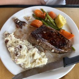Kids top sirloin with mashed potatoes and steamed veggies. Generous sized portion for kids. We took half of it to our hotel. Kids top sirloin with mashed potatoes and steamed veggies. Generous sized portion for kids. We took half of it to our hotel.