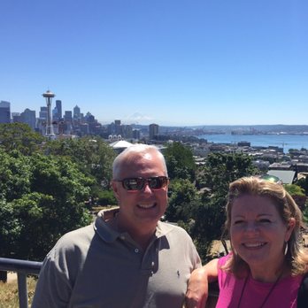 Show Me Seattle - Lucky taking a picture with the skyline beyond - Food Tours Near Me - Renton, Washington Show Me Seattle - Lucky taking a picture with the skyline beyond - Food Tours Near Me - Renton, Washington