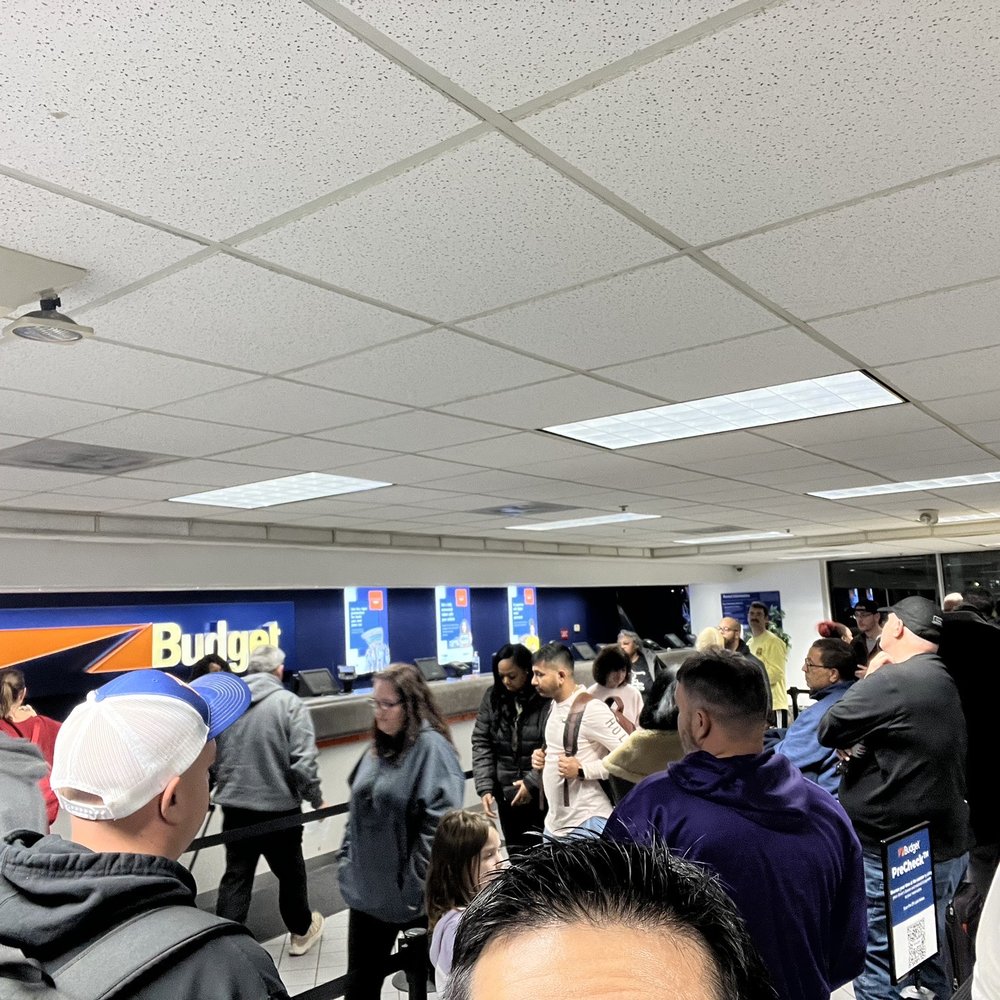 Budget - Weary travelers waiting in line. - Car Rental Near Me - Detroit, Michigan Budget - Weary travelers waiting in line. - Car Rental Near Me - Detroit, Michigan