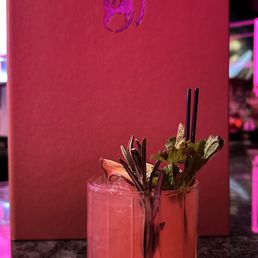 a pink cocktail in a glass a pink cocktail in a glass