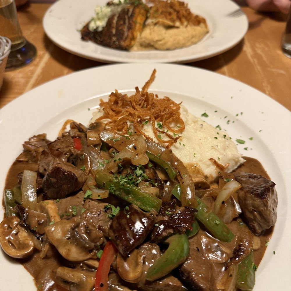 Sea bass in back and beef stroganoff in front Sea bass in back and beef stroganoff in front