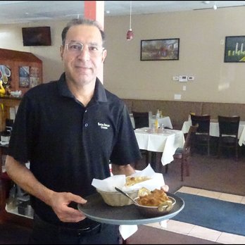 Royal Indian Cuisine - My friendly host brought a basked of naan bread, along with my entree of goat curry to my table with a smile. - Indian Near Me - Auburn, California