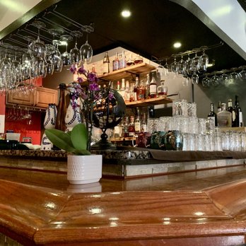 Longitud315 - a wooden bar with wine glasses on it - Latin American Near Me - Highwood, Illinois Longitud315 - a wooden bar with wine glasses on it - Latin American Near Me - Highwood, Illinois