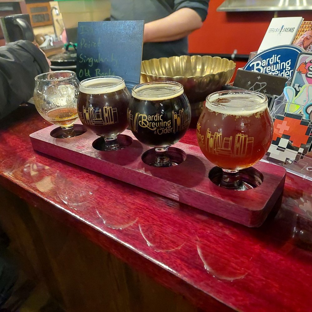 a flight of beers on a bar