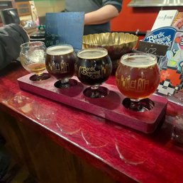 a flight of beers on a bar a flight of beers on a bar