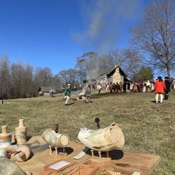 Ramsour's Mill Battleground - Sutlers table with baggage burning in the distance.