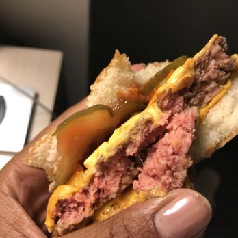 McDonald's - a hand holding a half eaten hamburger - Fast Food Near Me - Raleigh, North Carolina McDonald's - a hand holding a half eaten hamburger - Fast Food Near Me - Raleigh, North Carolina