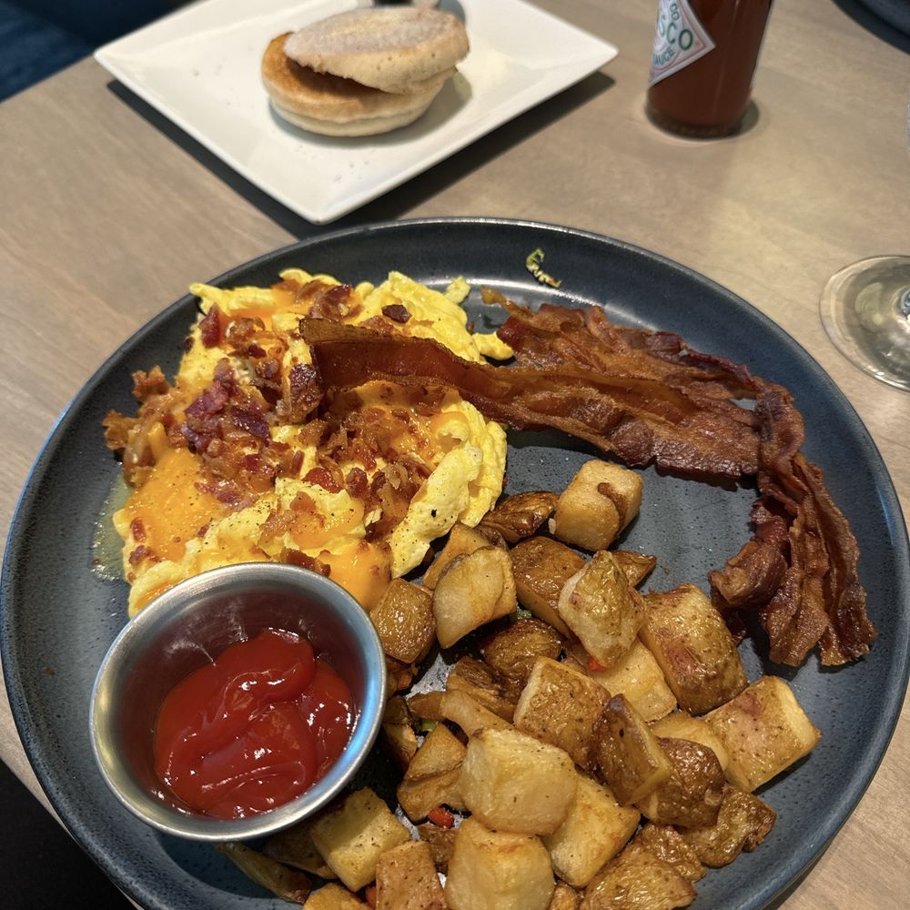 Eggs Your Way* with scrambled eggs and apple bacon with home fries and English muffin Eggs Your Way* with scrambled eggs and apple bacon with home fries and English muffin