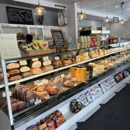 Deli style setting with meats, salads and cheeses in the glass case. Deli style setting with meats, salads and cheeses in the glass case.
