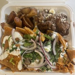 Chilaquiles with carne asada, beans and potatoes Chilaquiles with carne asada, beans and potatoes