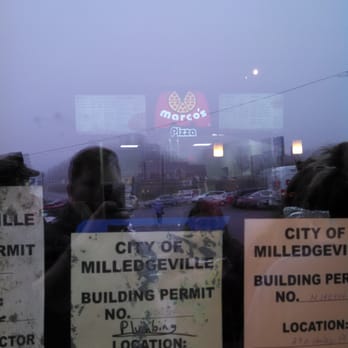 Marco's Pizza - the reflection of a man in a window - Pizza Near Me - Milledgeville, Georgia
