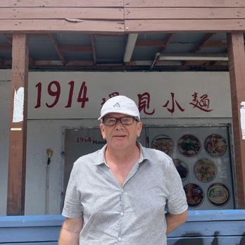 1914 Noodles and More - An unassuming shop front  with a satisfied diner. - Salad Near Me - Austin, Texas