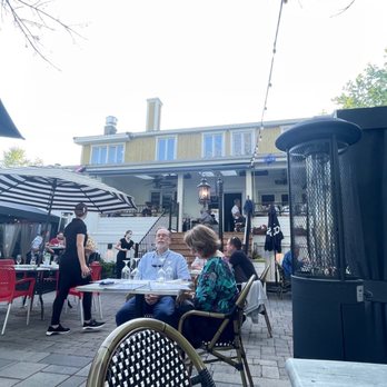 Bleu Moutarde - a group of people sitting at outdoor tables - French Near Me - Beloeil, Quebec