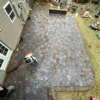 Paver Savers - Team putting sealer on the finished patio. - Masonry/Concrete Near Me