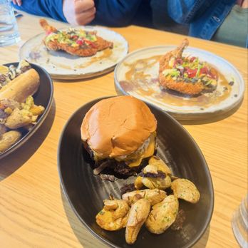 Stone Cellar Bistro - Chicken Schnitzel, Cheesesteak and a Black Angus cheeseburger with the most outstanding charred fingerling potatoes I've ever eaten. - New American Near Me - Arvada, Colorado