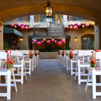 Perfect Parties By Mo - Magenta, red and orange colors in paper lanterns emphasize the architecture and small hanging chair arrangements line the aisle. - Florists Near Me - Auburn, California Perfect Parties By Mo - Magenta, red and orange colors in paper lanterns emphasize the architecture and small hanging chair arrangements line the aisle. - Florists Near Me - Auburn, California