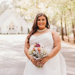 Evergreen Venue - Breide with bouquet in front of Evergreen Venue wedding chapel in Rainbow City, Alabama.  Credit:  SET Photography