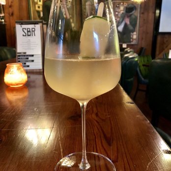 Single Barrel Room - a glass of white wine on a bar - New American Near Me - Charlotte, North Carolina