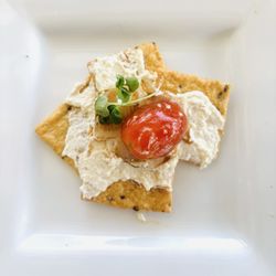 George's At Alys Beach - Gluten free crackers with cheese and a tomato