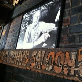 Captain Tony's Saloon - Fireplace mantel in the bar. The late Captain Tony in picture - Dive Bars Near Me - Key West, Florida Captain Tony's Saloon - Fireplace mantel in the bar. The late Captain Tony in picture - Dive Bars Near Me - Key West, Florida