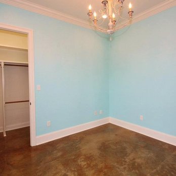 Concrete Revolution - an empty room with a chandelier - Flooring Near Me