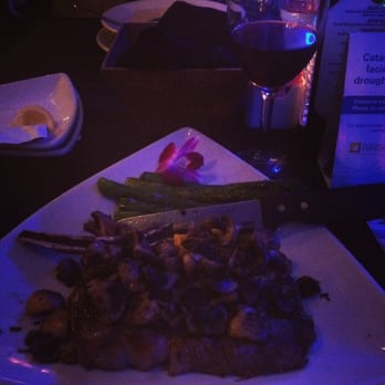 Steve's Steakhouse - a little dark (romantic) but my bone in rib eye with mushrooms was amazing - Steakhouses Near Me - Avalon, California