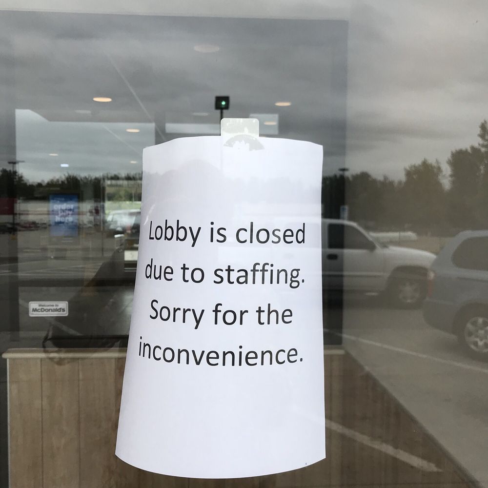 a sign in a window saying lobby is closed due to staffing sorry for the inconvenience