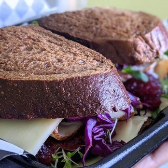 Four Corners Eatery - Turkey Cranberry on Sqaw (added red cabbage, alfalfa, cucumbers, etc.). - Delis Near Me - Redlands, California Four Corners Eatery - Turkey Cranberry on Sqaw (added red cabbage, alfalfa, cucumbers, etc.). - Delis Near Me - Redlands, California