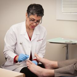 Pardis Kelly, DPM - Dr. Pardis Kelly examining a patient