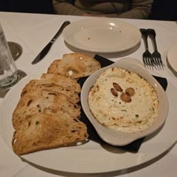 Baked Boursin cheese with roasted garlic and toast points.
