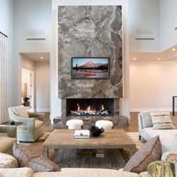 Innovative Stone Center - Wrapped floating fireplace