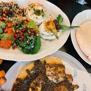 Suraya - On the table (fresh flatbread on the side), za'atar manoushe - Lebanese Near Me - Philadelphia, Pennsylvania Suraya - On the table (fresh flatbread on the side), za'atar manoushe - Lebanese Near Me - Philadelphia, Pennsylvania