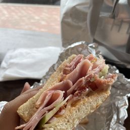 a person holding a sandwich a person holding a sandwich