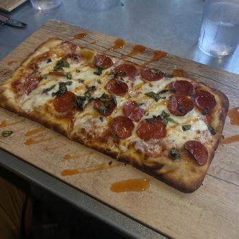 The Highlander - a pepperoni pizza on a cutting board - Dive Bars Near Me - Cleveland, Ohio The Highlander - a pepperoni pizza on a cutting board - Dive Bars Near Me - Cleveland, Ohio