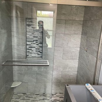 ProQual Constructions - a bathroom with a glass shower door - General Contractors Near Me