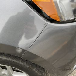 Hertz Rent A Car - More unrepaired accident damage on a bumper held together with string.