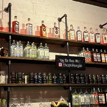 Deacon Giles Distillery - shelves of bottles and glasses - Distilleries Near Me - Salem, Massachusetts