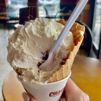 Cold Stone Creamery - a hand holding a cone of ice cream - Ice Cream & Frozen Yogurt Near Me - Duluth, Georgia