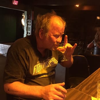 The Cinders Bar - a man drinking a glass of wine - Cocktail Bars Near Me - Sacramento, California