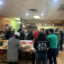 a group of people standing around a table