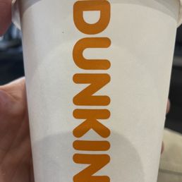 a hand holding a cup of dunkin donuts a hand holding a cup of dunkin donuts