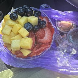 Açaí and pitaya bowl with mango, blueberries, strawberries, and peanuts butter and Nutella.