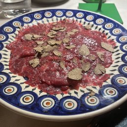 Black Angus carpaccio (ancient beef breed) with fresh truffle flakes
