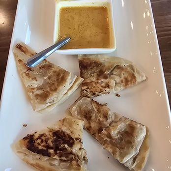 Thai Square - Roti dip, 8 pieces roti, yellow curry, and cucumbers - Thai Near Me - Richmond, Texas Thai Square - Roti dip, 8 pieces roti, yellow curry, and cucumbers - Thai Near Me - Richmond, Texas